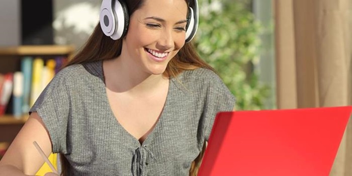 A stock photo of a person working in front of a computer.